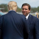 Then President Donald Trump is greeted by Florida Gov. Ron DeSantis at the airport in Fort Myers on Oct. 16, 2020.