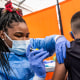 A health care worker administers a Pfizer-BioNTech COVID-19 vaccination to a child in San Francisco on Jan. 10, 2022.