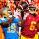 Kazmeir Allen #19 of the UCLA Bruins catches a pass and runs for a touchdown past Isaac Taylor-Stuart #6 of the USC Trojans in the first half of a NCAA football game in Los Angeles on Nov. 20, 2021.