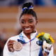 Simone Biles poses with the bronze medal during the Women's Balance Beam Final medal ceremony at the Tokyo 2020 Olympic Games on Aug. 3, 2021.