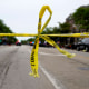 Police tape hangs at the corner of Central Avenue and Green Bay Rd., in Highland Park, Ill., after a mass shooting on Monday.