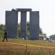Image: Law enforcement officials walk around the damaged Georgia Guidestones monument near Elberton, Ga., on July 6, 2022.