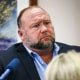 Conspiracy theorist Alex Jones attempts to answer questions about his emails asked by Mark Bankston, lawyer for Neil Heslin and Scarlett Lewis, during trial at the Travis County Courthouse in Austin on Aug. 3, 2022.