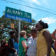 Image: Wanda Cooper-Jones, center in yellow dress, poses for photos with supporters beneath a new street sign honoring her son, Ahmaud Arbery, at the unveiling on Aug. 9, 2022, in Brunswick, Ga.