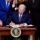 President Joe Biden signs the Inflation Reduction Act of 2022 into law during a ceremony in the State Dining Room of the White House in Washington, D.C. on Tuesday.