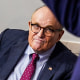 Former New York Mayor Rudy Giuliani listens as President Donald Trump speaks in the Briefing Room of the White House on Sept. 27, 2020.