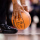 A referee lifts a basketball on the court during the second half of an NBA game between the Toronto Raptors and the Memphis Grizzlies on Nov. 30, 2021, in Toronto, Canada.