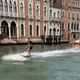 Tourists surfing along the Grand Canal in Venice.