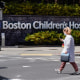 Pedestrians walk past a sign outside the Boston Children's Hospital on Aug. 18, 2022, in Boston.