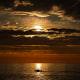 Image: An early-rising sport fisherman motors over calm seas on his way to striped bass fishing grounds off the coast of Kennebunkport, Maine, July 7, 2022.