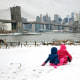 Children slide on a snow-covered hill in Brooklyn, N.Y., in 2019.