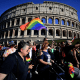 Participants hold rainbow flags during Rome Pride