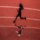 A female athlete runs on a track