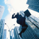 Businessman jumping, low angle view