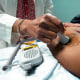 A doctor uses a hand-held Doppler probe on a pregnant woman to measure the heartbeat of the fetus, in Jackson, Mississippi, on Dec. 17, 2021.