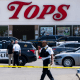 Law enforcement officials work at the scene of a mass shooting at Tops Friendly Market