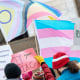 Image: People holding transgender pride flags and banners.
