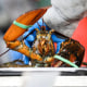 A worker weighs a lobster to sort in Arundel, Maine, on Jan. 24, 2022.