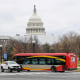 Buses drive past the US Capitol in Washington on Dec. 12, 2022.