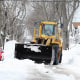 A loader removes snow from a residential street in Buffalo