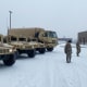 Soldiers from the 142nd Field Artillery Brigade in Lowell, Ark., prepare as inclement weather bears down on the region on Jan. 30, 2023.