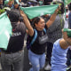 Feminist demonstrators wave green scarves during a demonstration on International Safe Abortion Day