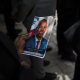A guest holds a picture of late Haitian President Jovenel Moise during a ceremony in Port-au-Prince, Haiti, on July 20, 2021.