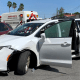 A member of the Mexican security forces stands next to a white minivan with North Carolina plates and several bullet holes, at the crime scene where gunmen kidnapped four U.S. citizens who crossed into Mexico from Texas, Friday, March 3, 2023. Mexican President Andres Manuel Lopez Obrador said the four Americans were going to buy medicine and were caught in the crossfire between two armed groups after they had entered Matamoros, across from Brownsville, Texas, on Friday. (AP Photo)