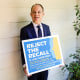 Judge Aaron Persky holds a sign opposing his recall in Los Altos Hills, Calif., on May 15, 2018.