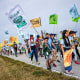 Image: Gelder Perez, 10, center, carries a protest flag as he walks with his uncle Leonel Perez, center right, on the first day of a five-day trek aimed at highlighting the Fair Food Program, in an effort to pressure retailers to leverage their purchasing power to improve conditions for farmworkers, on March 14, 2023, in Pahokee, Fla. 