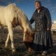 Marilyn Help-Hood stands next to her horse on March 13 in Tohlakai, N.M.. 