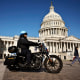 A U.S. Capitol Police officer drives his motorcycle across the East Front Plaza as tourists visit the Capitol building on March 20, 2023 in Washington, DC. The security posture in Washington appeared normal on Monday after former President Donald Trump called for protests after he announced on social media that he expected to be arrested this week and charged with breaking campaign finance laws for paying an adult film star hush money during the 2016 presidential election.