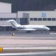 An emergency vehicle is parked near the Bombardier Challenger 300 that diverted to Bradley International Airport in Windsor Locks, Conn., on March 3, 2023.