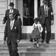 U.S. Deputy Marshals escort 6-year-old Ruby Bridges from William Frantz Elementary School in New Orleans, in this November 1960, file photo. New Orleans is marking the 61st anniversary of the integration of its public schools by four 6-year-old girls. Weekend events began with a Friday morning news conference at New Orleans City Hall and an evening screening of a video tribute to the four. A special church service and a motorcade are set for Sunday, Nov. 14, 2021.