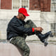 Harry Martin, founder of The Roller Wave, laces up his skates in a Harlem Park.