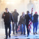 Supporters of President Donald Trump enter the Capitol as tear gas fills the corridor on Jan. 6, 2021.