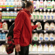 A customer takes a gallon of milk from a  store shelf in Salt Lake City,