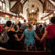 People hold hands at Mother Bethel African Methodist Episcopal Church