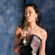 Michelle Yeoh kisses her award at the Vanity Fair Oscar Party
