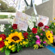 Flower bouquets are displayed as a memorial to victim's of Sunday's shooting as survivors and church leaders join in prayer and thank community members for their support nearly a week after a deadly shooting at a Taiwanese American church congregation Saturday, May 21, 2022, in Laguna Woods, Calif. The community is reeling after the attack on a luncheon of the Irvine Taiwanese Presbyterian Church that killed one and wounded five.