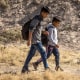 Guatemalan migrants walk along the U.S. side of the Rio Grande after crossing over from Mexico on May 13, 2023, to El Paso, Texas. 