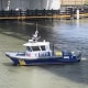 An NYPD patrol vehicle searches the Harlem river during the search for missing Garrett Warren.