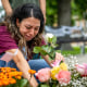 UVALDE, TEXAS - MAY 24: nAngeli Rose Gomez, a mother who rushed into Robb Elementary School to save her two children, places roses down at a memorial dedicated to the 19 children and two adults murdered on May 24, 2022 during the mass shooting at Robb Elementary School on May 25, 2023 in Uvalde, Texas. Today marks the 1-year anniversary of the mass shooting at Robb Elementary School. 19 children and two teachers were killed when a gunman entered the school, opening fire on students and faculty.