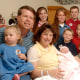 Michelle Duggar, left, is surrounded by her children and husband Jim Bob, second from left, after the birth of her 17th child in Rogers, Ark.