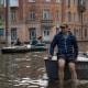 Volunteers carry local residents on boats during an evacuation from a flooded area in Kherson
