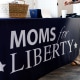 A woman organizes Moms for Liberty apparel at the inaugural Moms For Liberty Summit