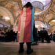 A demonstrator wears a transgender flag as a counter-protest during a rally in favor of a ban on gender-affirming health care legislation on March 20, 2023, at the Missouri Statehouse in Jefferson City.