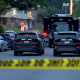 Police cars attend a mass shooting in Baltimore early Sunday morning, in which at least two people died.