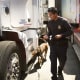 A U.S. Customs and Border Protection officer and his canine companion inspect a tractor trailer at the Otay Mesa, Calif., port of entry June 23, 2016.