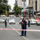 Image: Armed New Zealand police officers stand at a road block in the central business district following a shooting in Auckland, New Zealand, on July 20, 2023.